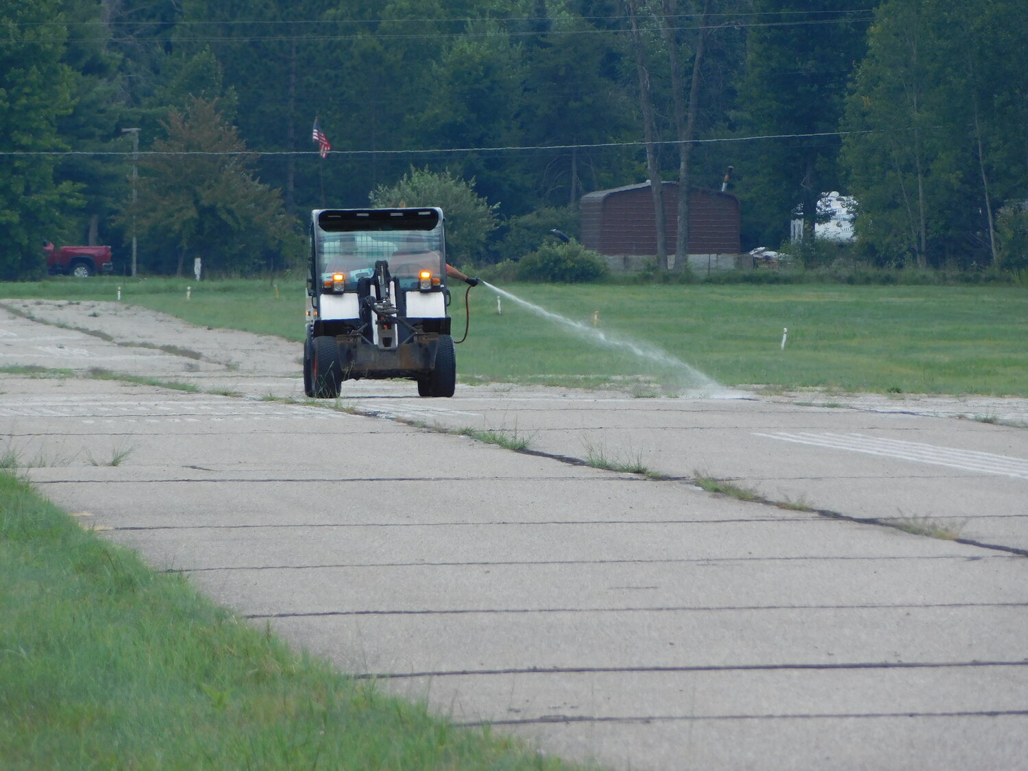 Shown here is a long view of the airport’s paved runway and the Aug. 4 weed spraying.